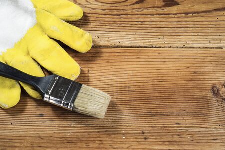 gloves and brush on wooden backgroundの写真素材