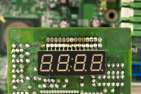 electronic circuit board  and digital clock show zero hours zero minutes