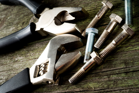 tools and bolts on wooden background, selective focus の写真素材
