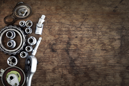 tools and old auto parts on wooden backgroundの写真素材
