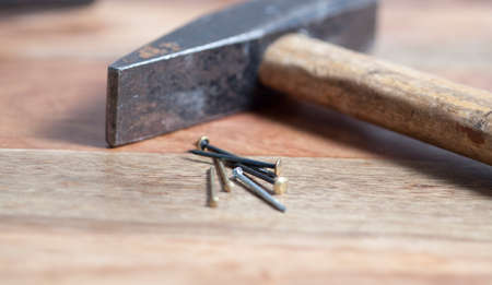 hammer with nails on wooden backgroundの写真素材