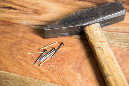 hammer with nails on wooden backgroundの写真素材