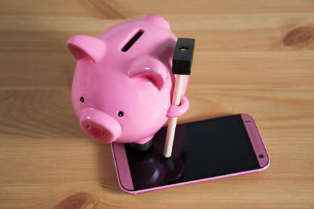 Piggy bank on a mobileの写真素材