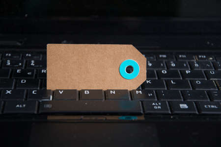 a paper tag on a keyboardの写真素材