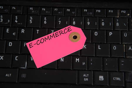 e-commerce written on paper tag on a keyboardの写真素材