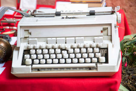 a white typewriter on a flea marketの写真素材