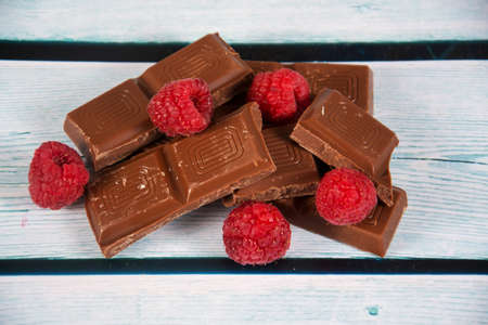 some broken chocolate with raspberryの写真素材