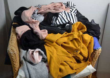 Pile of clothes on a chairの写真素材