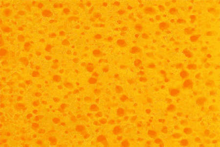 Springy texture of a sponge or foamy orange materialの写真素材
