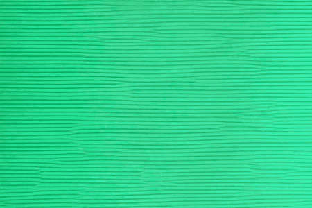 Ribbed texture of a green cardboard with horizontal lines