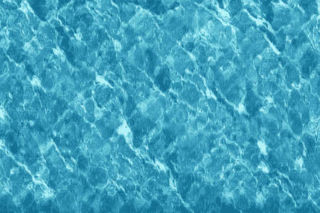 Texture of water in a swimming pool with light reflectionsの写真素材