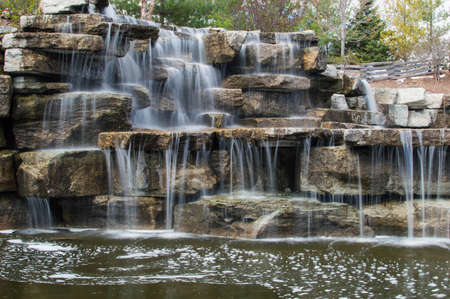 A beautiful rocky waterfall in the sun.の写真素材