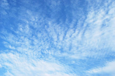 delicate white clouds adorn the bright blue sky