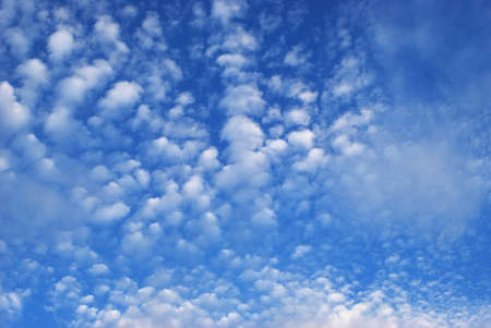 delicate patterns of white clouds in the blue sky