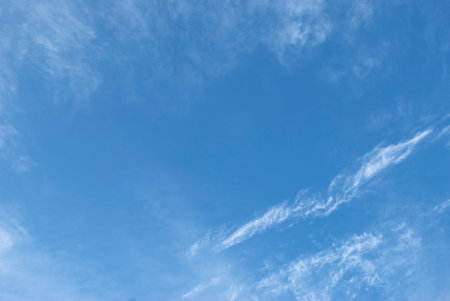 gentle white clouds in a bright blue skyの写真素材