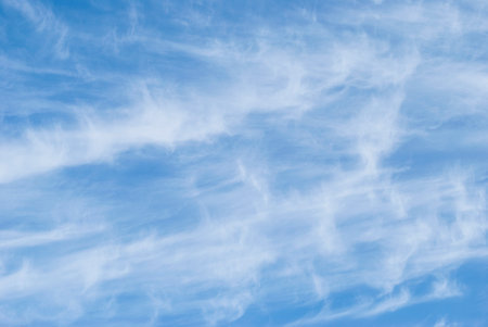 gentle cirrus clouds in a bright blue sky