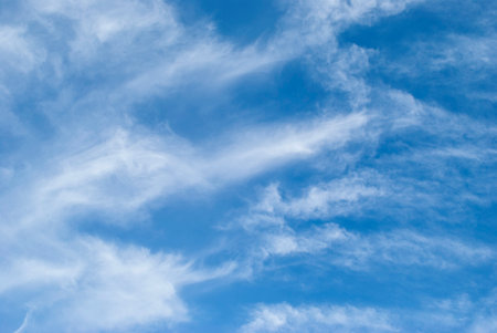 gentle cirrus clouds in a bright blue sky