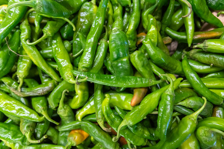 Green hot chili peppers on display at a farmers market in India.