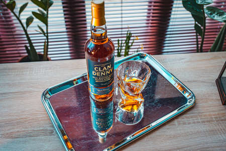 Whiskey bottle with glass and cigar.の写真素材