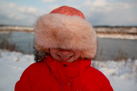 young girl playing with snow in parkの写真素材