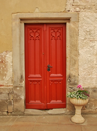 Red entrance door in front of residential houseの写真素材