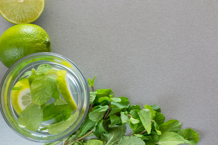 Mojito cocktail with lime and mint in highball glass on a grey stone backgroundの写真素材
