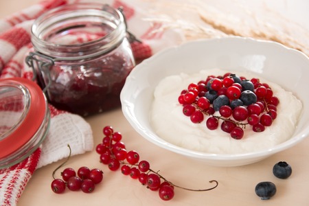 cottage cheese with berries and yogurt for breakfast closeupの写真素材