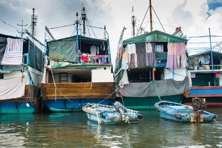 HAINAN, CHINA - 12.09.2016: fishing village of poor people on the sea water in island Hainan, Chinaの写真素材