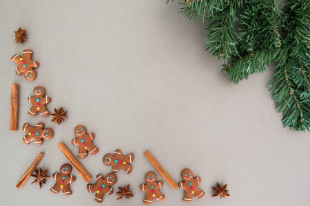 Christmas fir tree and gingerbread cookies on grey board