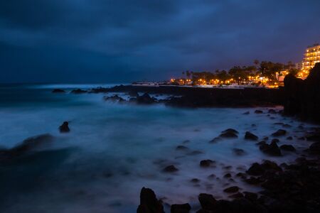 View of night Puerto de la Cruz in Tenerife, Canary Islands, Spain. Long exposure night scene showing the waterfront.の写真素材