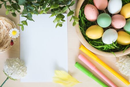 Easter eggs and other decorations on wooden background