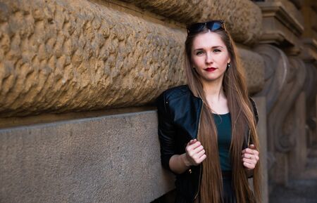 Modern young woman on the street of old europian cityの写真素材