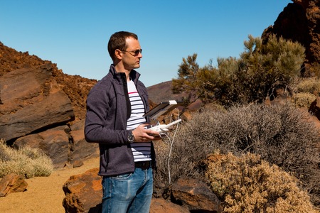 TENERIFE, SPAIN - 13.02.2017: Man with remote controlling drone DJI Phantom 4 in Tenerife, Spainのeditorial素材
