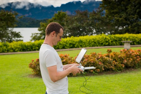 PHUKET, THAILAND - 8.11.2016: Man with remout controling drone DJI Phantom 4 in Phuket, Thailandのeditorial素材