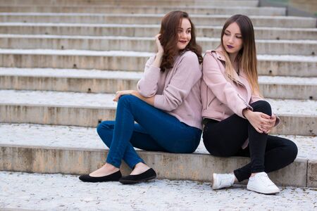 Two beautiful young women having fun on street of the cityの写真素材