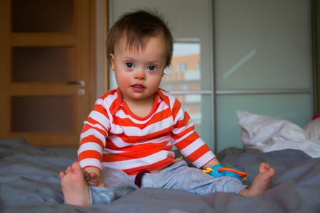 Portrait of cute baby boy with Down syndrome