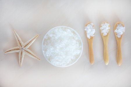 Sea Salt with spoon and starfish on wooden backgroundの写真素材
