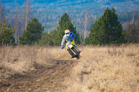 Pribram, Czech republic - 11.03.2018: Motocross rider in action on the off-road in nature next to small czech town Pribramのeditorial素材