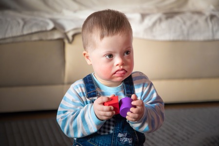 Portrait of cute baby boy with Down syndrome