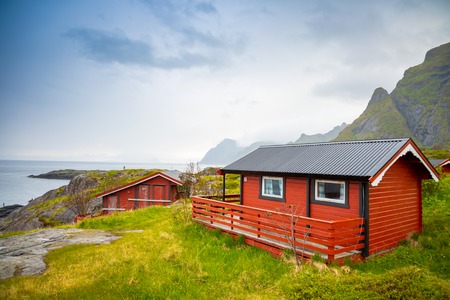 Traditional red camping houses with a beautiful sea view next to village A in lofoten, Norwayの写真素材