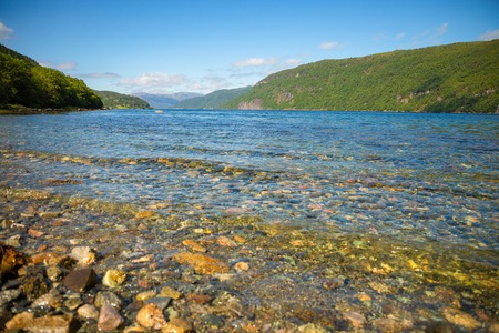 Summy weather and blue water of fjord in Norway