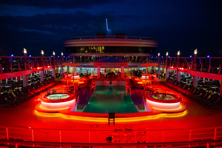 Mediterranean Sea, 14.10.2018: The swimming pool onboard Norwegian Cruise Line illuminated at night during drivingのeditorial素材