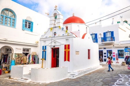 Mykonos, Greece - 17.10.2018: Agia Kyriaki Church, typical Greek church white building with red dome against the blue sky on the island Mykonos in Greeceのeditorial素材