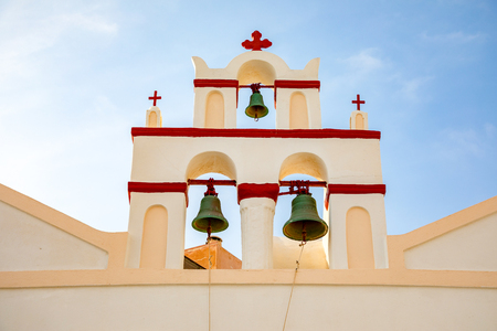The bell tower of a church in Oia set against a deep blue sky, Santorini in Greeceの写真素材