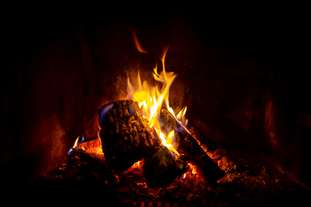 Close up shot of burning firewood in the fireplaceの写真素材