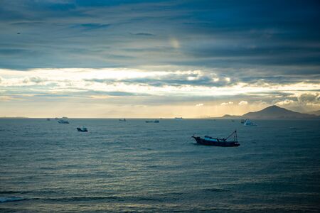 Fishing boat on sea in sunset lights in Sanya, Hainan in Chinaの写真素材