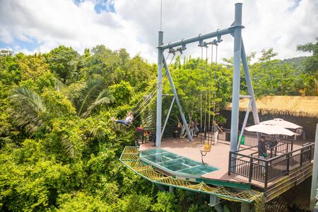 Yanoda, Hainan, China - 3.07.2019: People on panorama glass bridge in the Yanoda rain forest park on Hainan Island in the city of Sanya in Chinaのeditorial素材