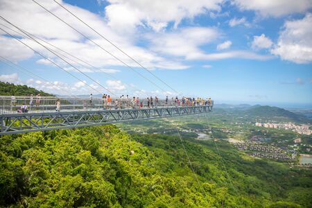 Yanoda, Hainan, China - 3.07.2019: People on panorama glass bridge in the Yanoda rain forest park on...