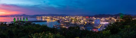 Sanya, Hainan, China - 7.07.2019: Night view of Phoenix island and Sanya city illuminated with city lights. View from Luhuitou Park on Hainan Island in Chinaのeditorial素材