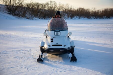 Kemerovo, Russia - 23.02.2019: Rider on the snowmobile in nature of Siberia in Russiaのeditorial素材
